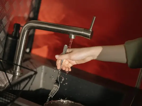 Plumber fixing a tap in a Kent home